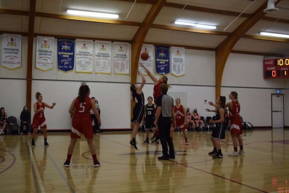 Zoe Thomas (lighter uniform) went up high to control the opening tip for the Canora Composite School Cougars senior girls basketball team at the CCS tournament on February 5. Other starters for the Cougars, from left, were: Robin Skurat, Elley Tomcala, Bree Woloshyn, and Lexie Biletski. / Rocky Neufeld