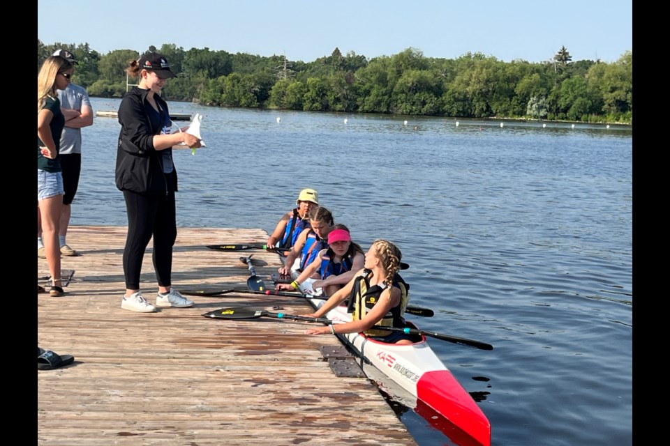 Coach Elia Bolme with the Yorkton Canoe and Kayak U12 K4.