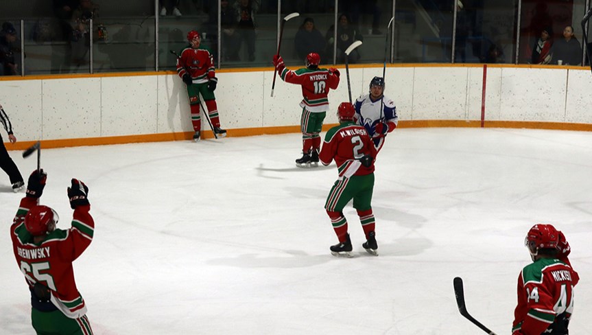 After scoring the winning goal for the Cobras late in the third period, William Hauber (along boards) celebrated with his teammates. 