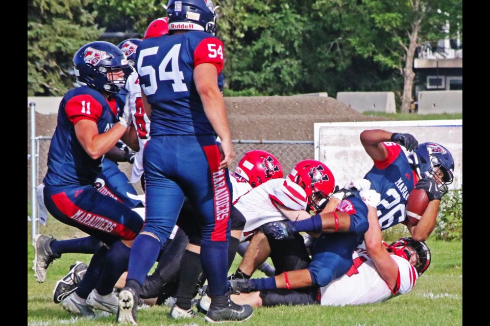 Weyburn Comp Eagles defenders bring down a Miller ball carrier early on in Friday's exhibition action.