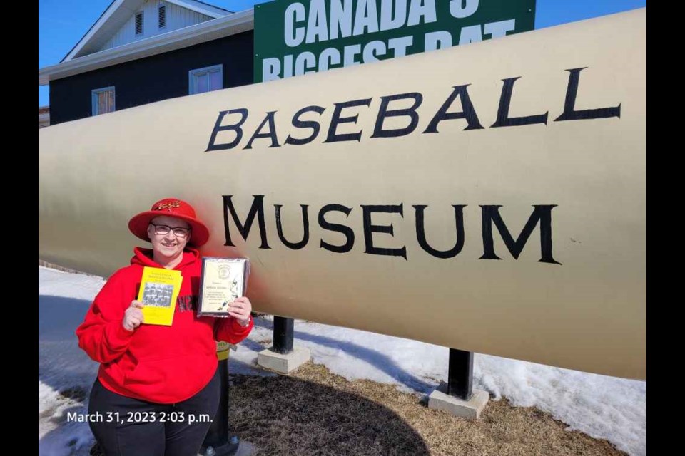 Shelley Fillipchuk picked up the plaque celebrating the Kamsack Cyclones being inducted in the Saskatchewan Baseball Hall of Fame.