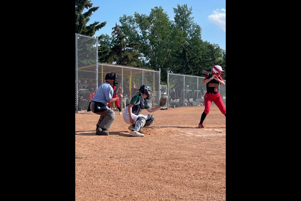 In a familiar position, Devyn McLean back catching with the U of S Softball team in opening weekend action 