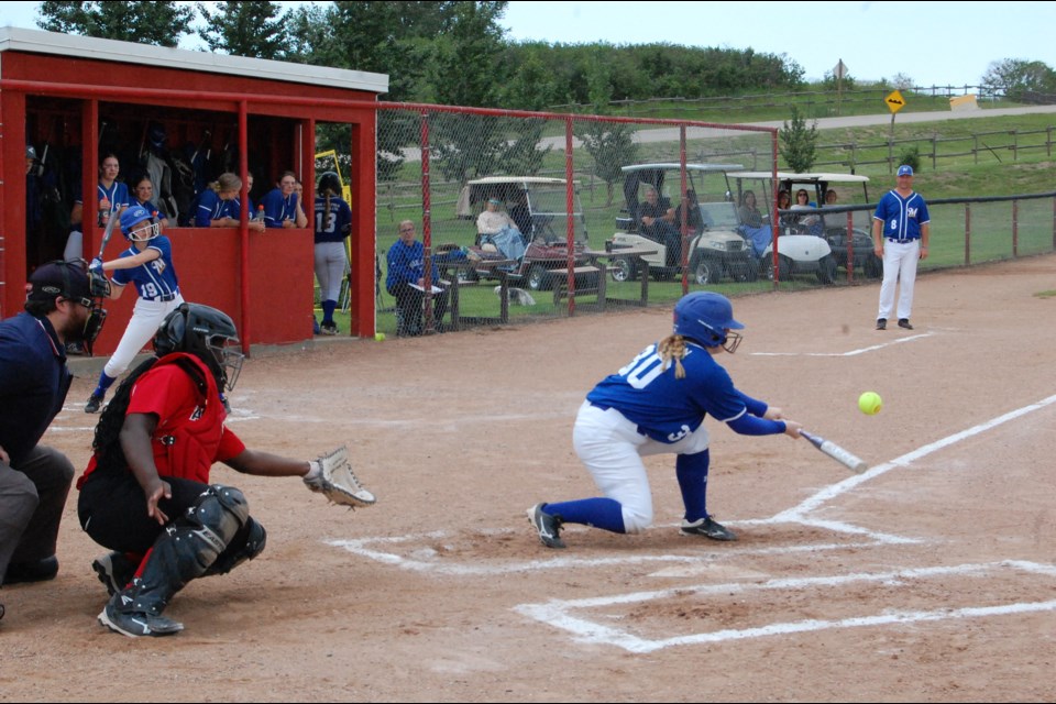 Abbey Folk bunts the ball while Rosetown back catcher Nikia Schlosser waits for it to hit her mitt.