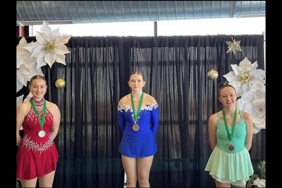 From left, Alicja Jedrezejowska, Madzia Szlapacka, Rachel Duncan and Sydney Brooks show the medals they won on Dec. 9. 