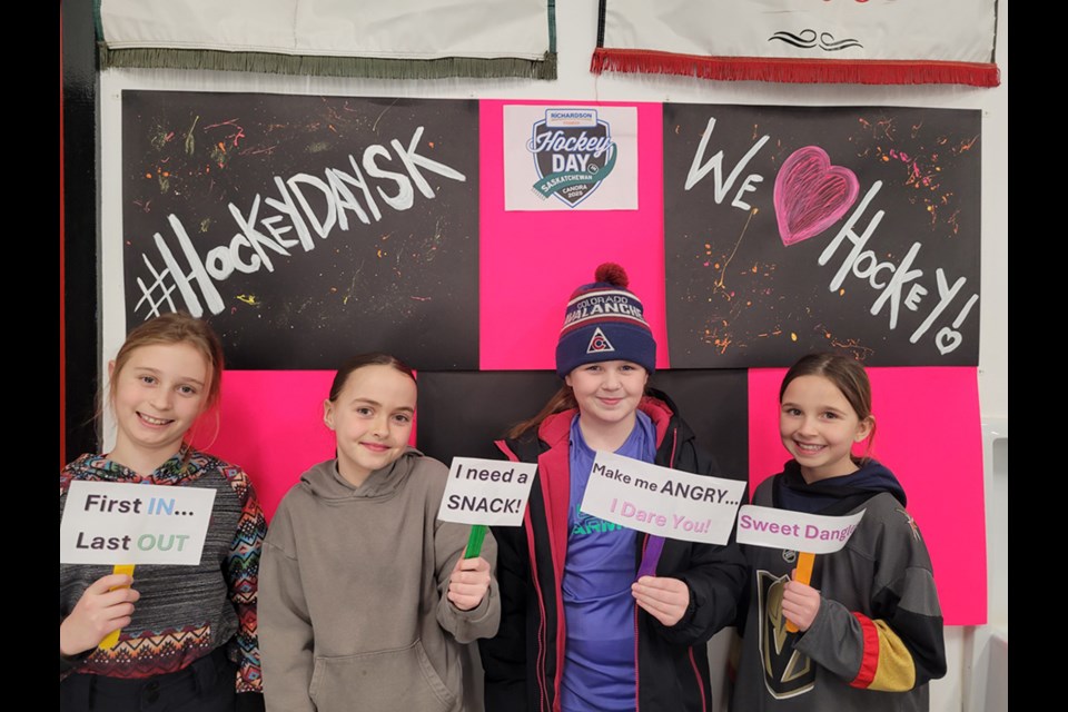 Day 1 of Hockey Day in Saskatchewan featured female hockey, including team building. From left: Aliannah Herriges, Frankie Nagy (Yorkton), Mae McTavish, and Ava Sliva had their picture taken in the photo booth. Photo by Brigitte Herriges