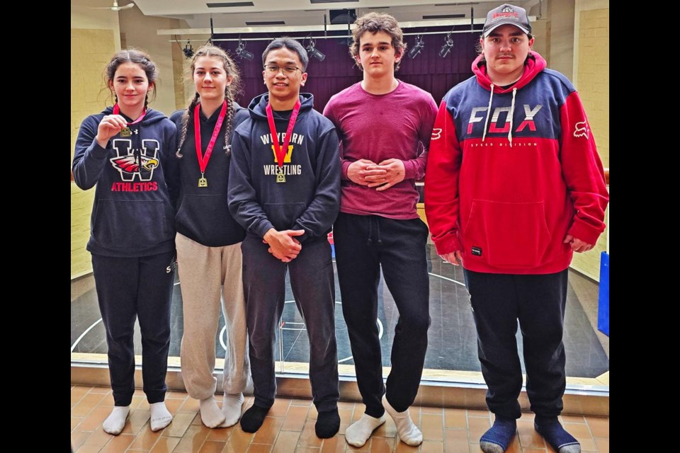 The high school team of wrestlers from Weyburn took in the SHSAA Regionals in Rosetown on March 2. From left are Avlynn Drake, Khloe Higgins and Chris Dayaan, each with a gold medal; and Trotter Drake and Raiden Kiraly with silver.