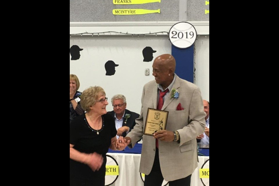 SBHOF board member, Jane Shury, helps present Fergie Jenkins an honorary award in 2019.