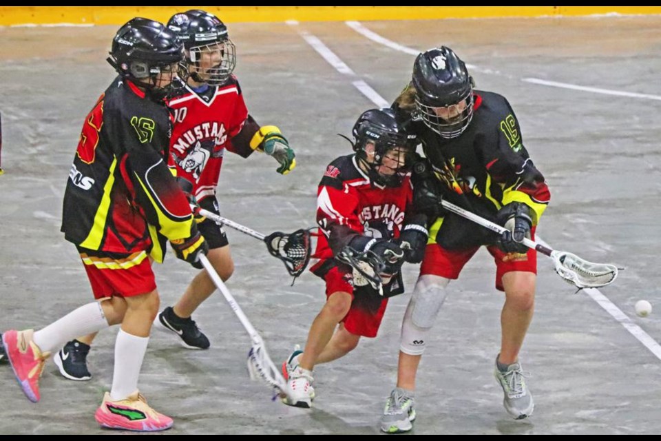 Weyburn U13 player Ryder Stepp, at right, went after a loose ball along with a Moose Jaw player during a playoff game on Friday.