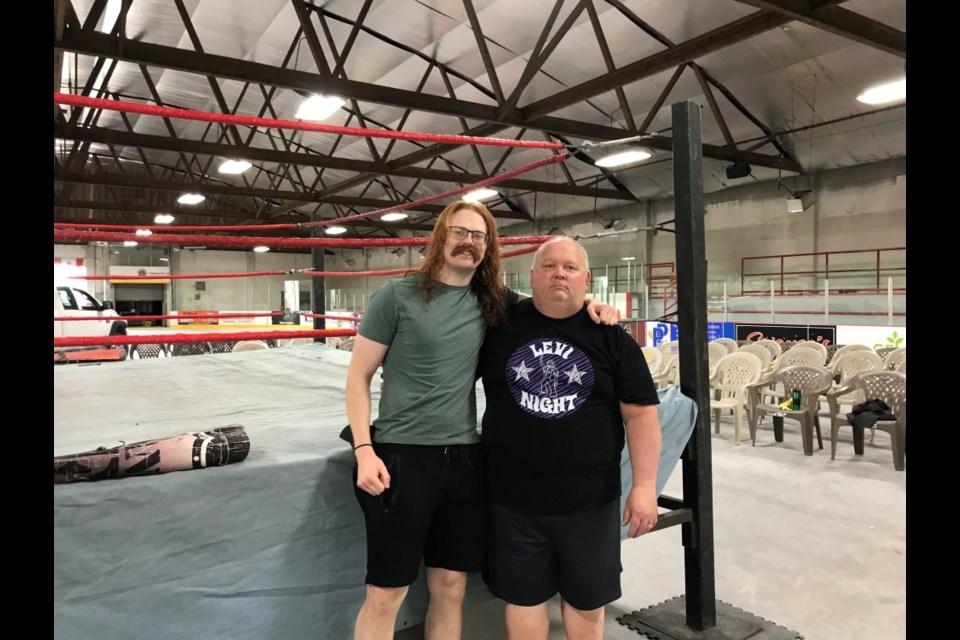 Levi Day, who wrestles under the name Levi Night, with his dad Larry Day before the match on Sunday. 
