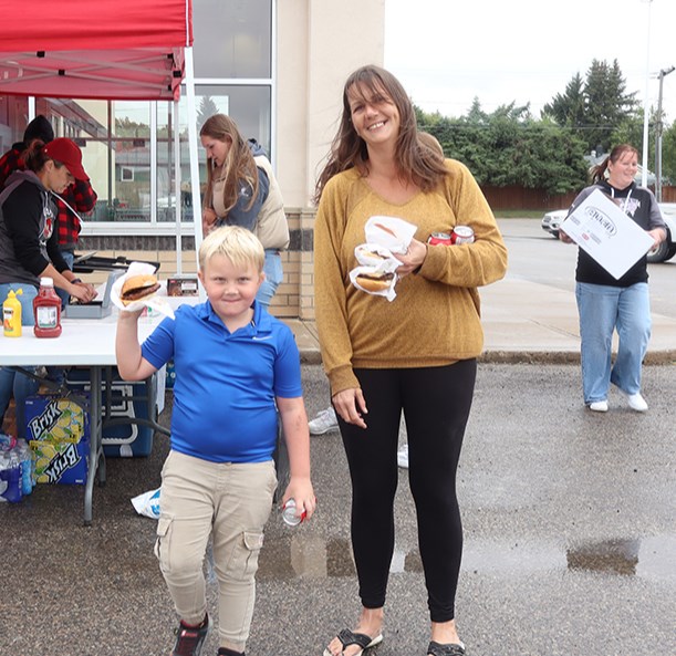 Remi Desrochers brought his mom, Blare Stewart, to enjoy the Canora Minor Hockey Barbecue on Sept. 12 outside the Gateway Co-op Food Store. Even though the day was overcast with occasional rain, approximately 400 burgers were sold.