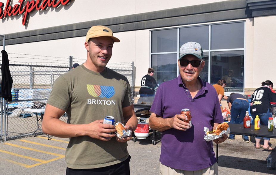 On a warm, sunny Sept. 8, the Canora Minor Hockey barbecue was held outside the Gateway Co-op Food Store. Among those enjoying their burgers were Dan Polischuk, left, and Glen Leson. Stacy Vangen, Canora Minor Hockey President, reports that the fundraiser “was extremely successful with approximately 280 burgers being sold. We are very grateful for the support we received from the community.”  