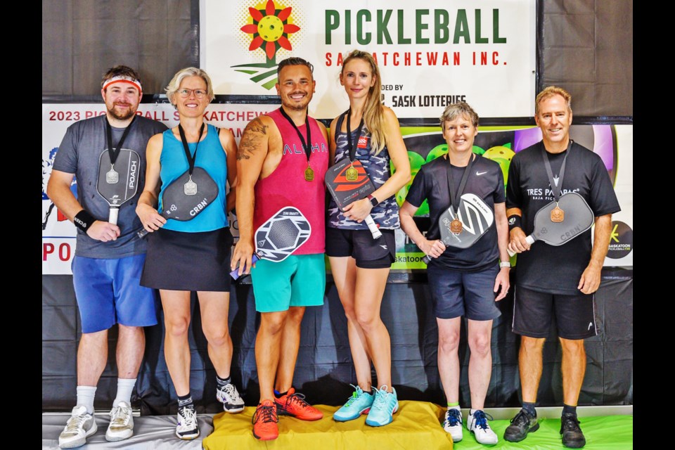 The winners of the mixed doubles event, 4.5 level, gathered with their medals, and winning bronze, at right, are Deana Mainil and Brian Mayrs.