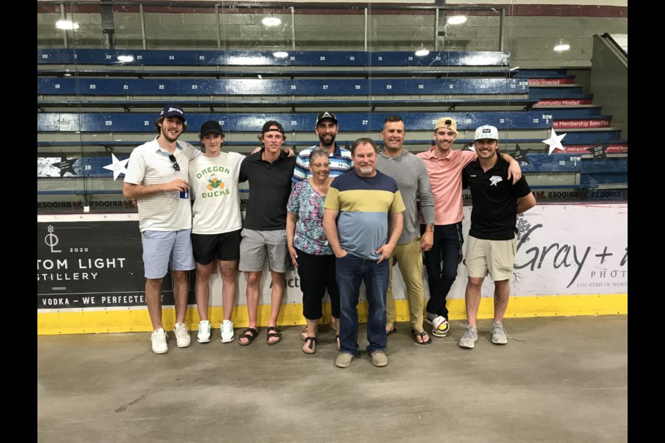 Members of the Battlefords North Stars pose with Kara and Kent Rosen, volunteers and billet parents.