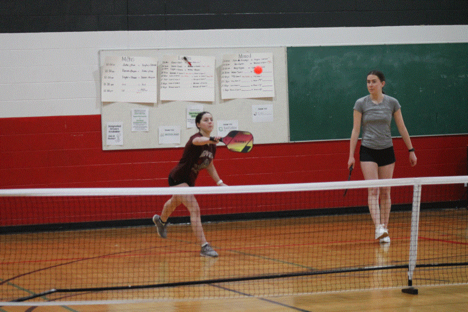 Layla Kitz showing good pickleball form while teammate Olivia Fonstad looks on. 