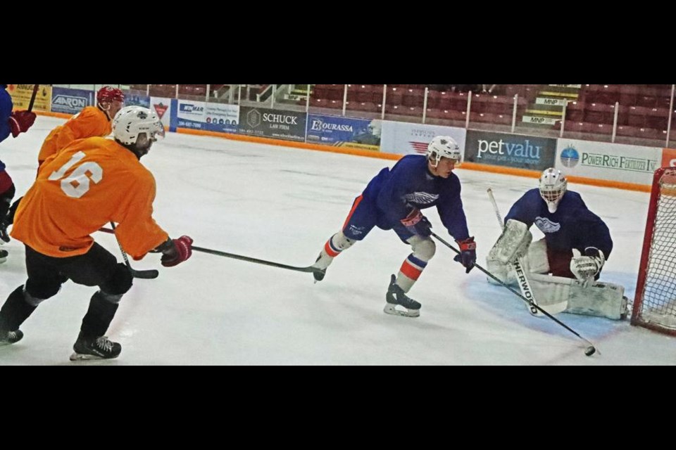 A player for Team Yellow tried coming in to get a shot on Team Blue's net, during a scrimmage game at the Weyburn Red Wings training camp on Saturday evening.