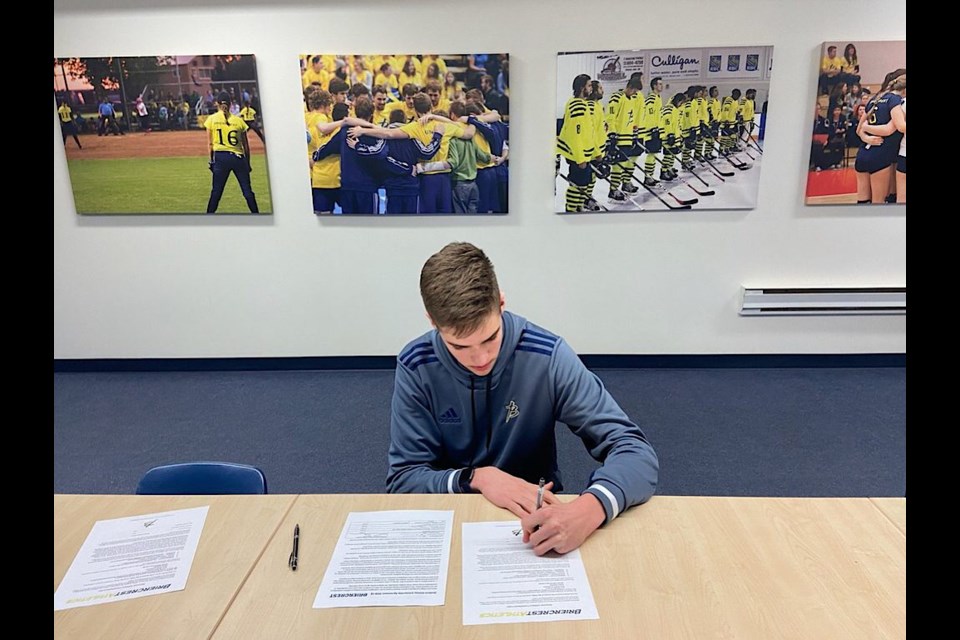 Marc Revet seen here signing with Briercrest College