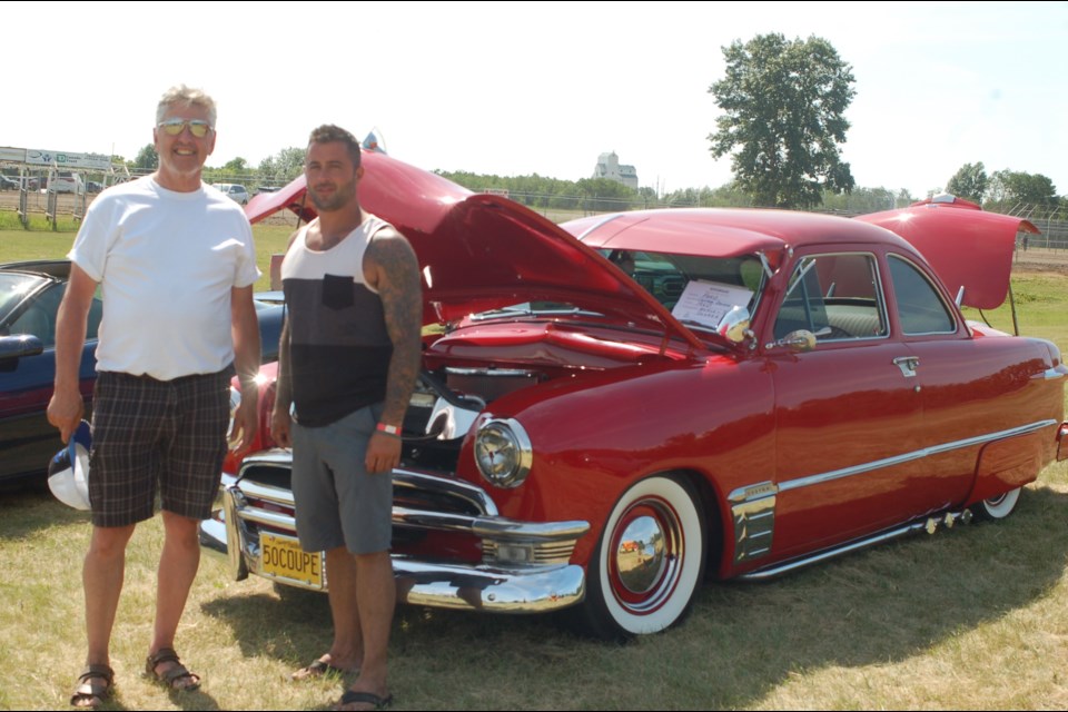 The People’s Choice Award during the car show and shine at the Sturgis Sports and Rodeo was won by John Dvorak, left, of Swan River for his 1950 Ford Coupe. Taylor Burym made the presentation. 