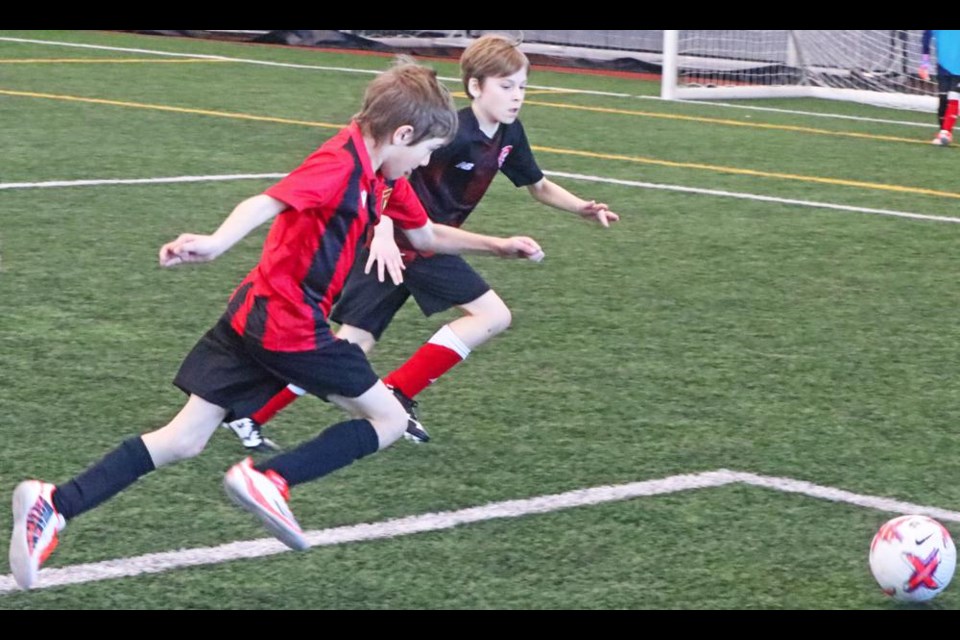 A Weyburn U11 player raced against a Yorkton player to get to the ball, during "Frostival" action on Saturday at the CU Spark Centre.