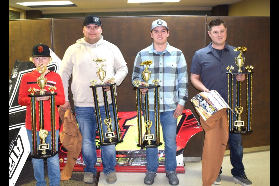 From left, Brogan Wagner (slingshots), Connor Hanson (hobby stocks), Kody Scholpp (modifieds) and Gabriel Deschamp (sport mods) with their championship trophies. Missing is Austin Daae.