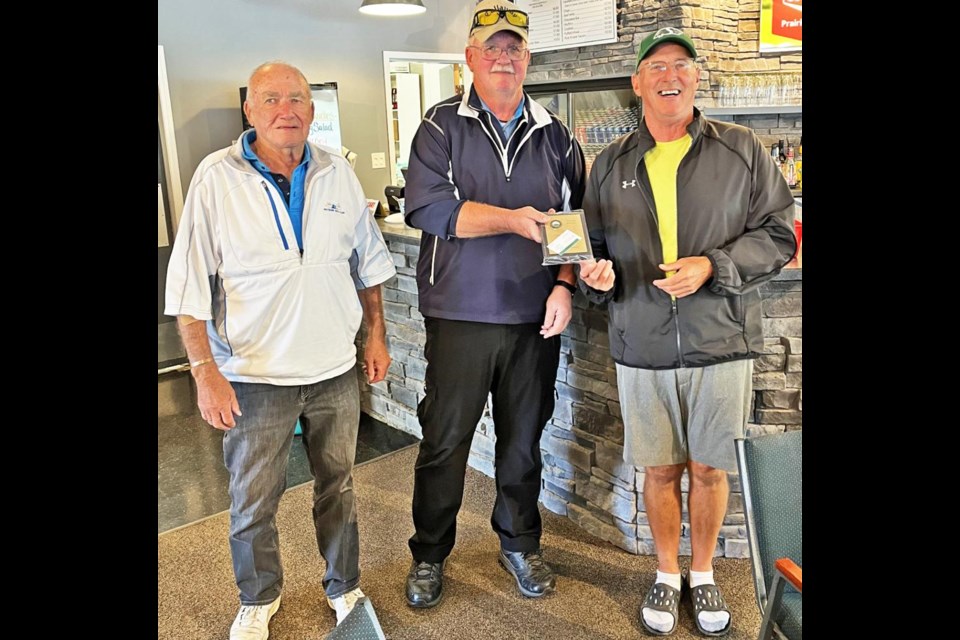 In the 50-69 age category, Kelly Hilkewich received the most points and won the trophy from executive members George McLeod and Don Mackinnon.