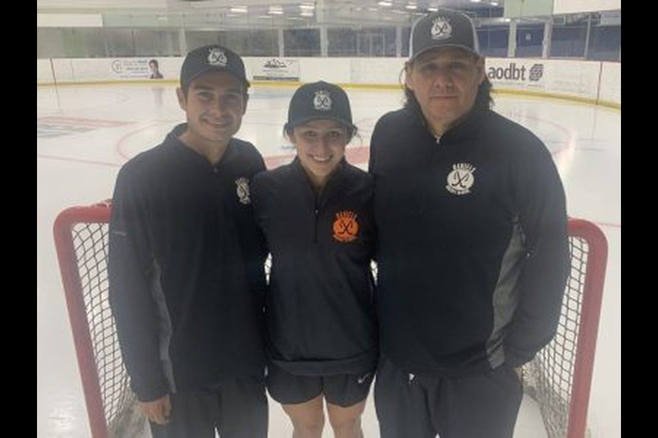 Sydney Daniels (centre) stands with her father, former NHLer Scott Daniels (left) and cousin Colby Daniels.