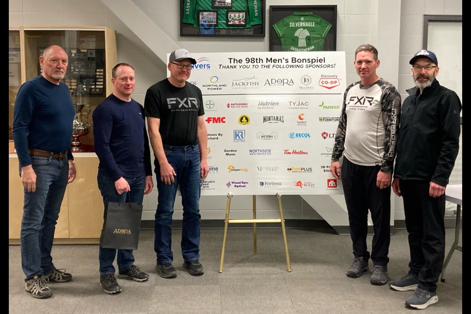 Twin Rivers Curling Club president Al Gabert presents Rob Bakken and his team of third Brent Taylor, second Trevor Gerein and lead Owen Gentes with the A event trophy at the conclusion of the club’s 98th annual open men’s bonspiel. 