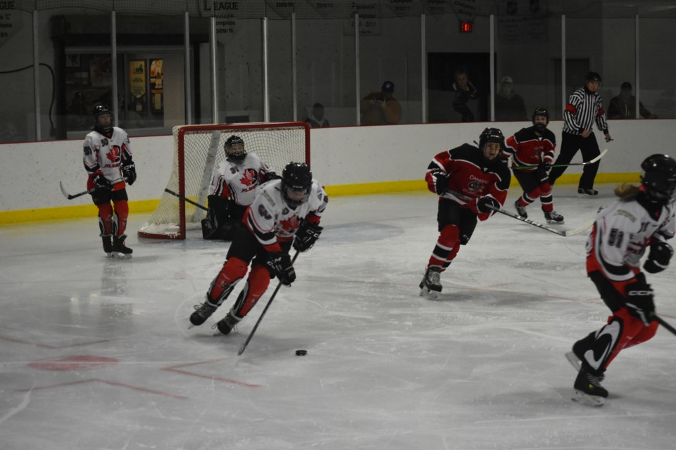 Kamsack Flyer Liam Shabatoski wheeled the puck away from the Kamsack goal, chased by two Canora Cobras.