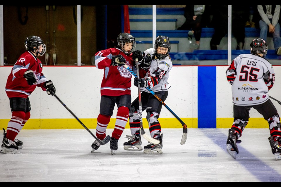 Wearing their white jerseys Angel Sliva of Canora (left) and Bryden Leis of the U13 Parkland Predators battled against Wynyard in Game 1 of the first round of provincials, with the Predators winning the series.