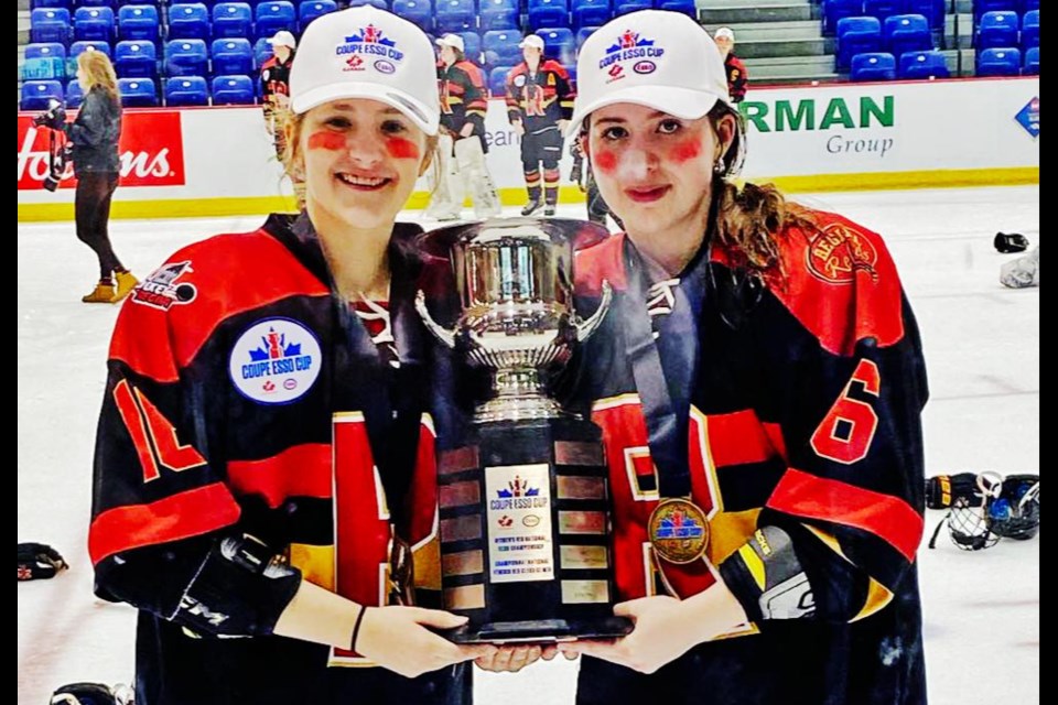 Ella Schenher and Addison Greve, both of Weyburn, hold the Esso Cup after winning the national championship on Saturday with the Regina Rebels in Vernon, B.C.