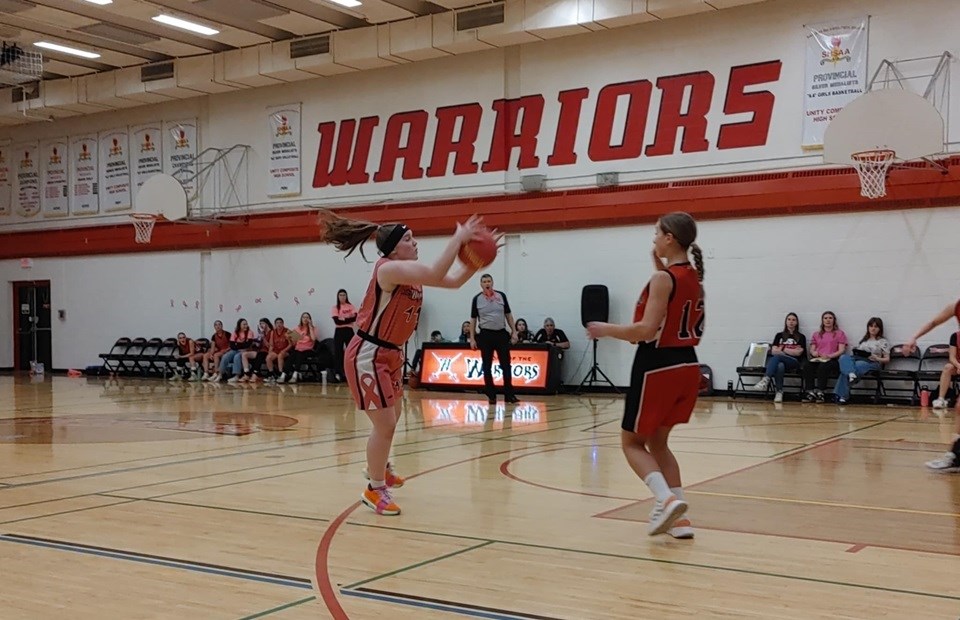 With a fast-paced game against the Langham Vikings, Kasey Parker catches the ball while her teammates position themselves for the offensive play.