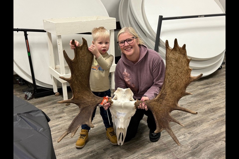 Ayven Jakubowski, left helped his mom Taylor display her moose antlers at the Preeceville Wildlife antler measuring at the Preeceville Community Legion Hall.