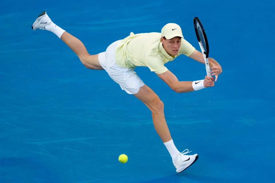 Jannik Sinner of Italy plays a backhand return to Ben Shelton of the U.S. during their semifinal match at the Australian Open tennis championship in Melbourne, Australia, Friday, Jan. 24, 2025. (AP Photo/Manish Swarup)