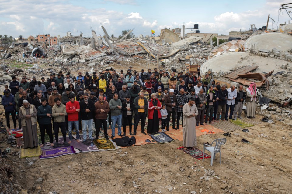 Palestinians perform Friday prayers near the ruins of a mosque destroyed by Israeli airstrikes in Khan Younis, Gaza Strip, Friday, Jan. 24, 2025, days after the ceasefire deal between Israel and Hamas came into effect. (AP Photo/Jehad Alshrafi)