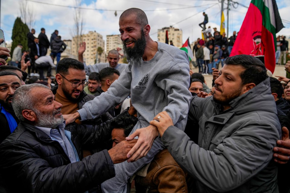 Palestinian prisoners are greeted by a crowd after being released from Israeli prison following a ceasefire agreement with Israel, in the West Bank city of Ramallah, Saturday, Jan. 25, 2025. (AP Photo/Nasser Nasser)