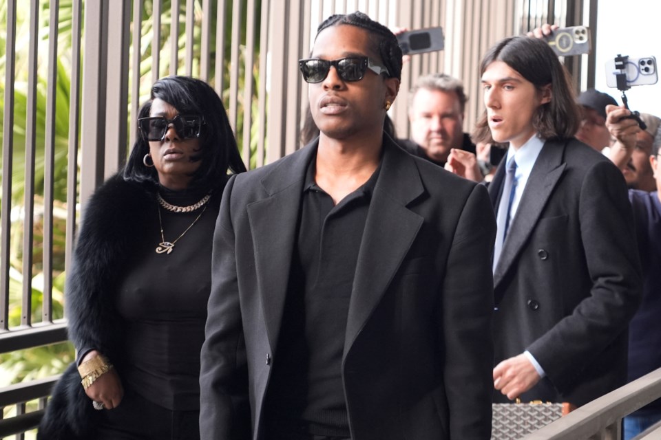 Grammy-nominated rapper A$AP Rocky, center, facing two felony counts of assault with a semiautomatic firearm after allegedly shooting at a former friend in 2021, arrives at the Clara Shortridge Foltz Criminal Justice Center in Los Angeles, Wednesday, Jan. 22, 2025. (AP Photo/Damian Dovarganes)