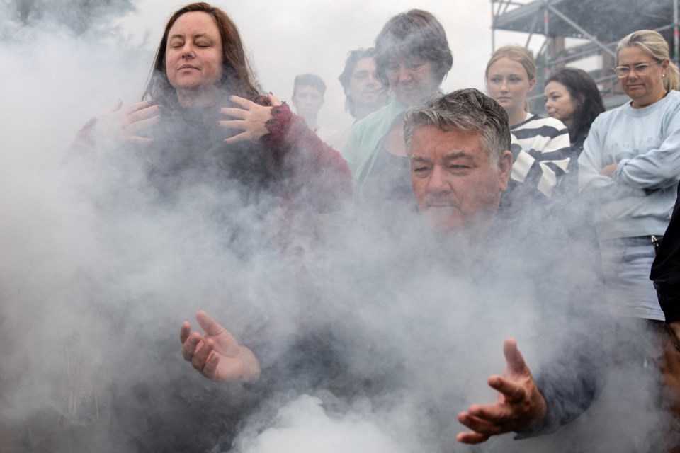 People gather for a traditional Aboriginal smoking ceremony during the We-Akon Dilinja Mourning Reflection Ceremony on Australia Day in Melbourne, Sunday, Jan. 26, 2025. (Diego Fedele/AAP Image via AP)