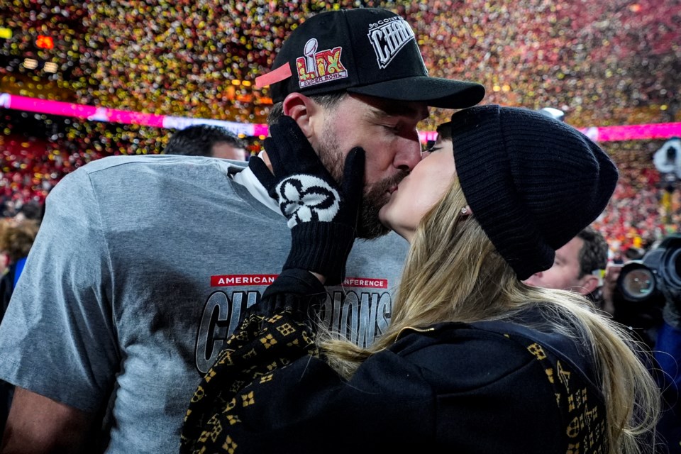 Kansas City Chiefs tight end Travis Kelce and Taylor Swift kiss after the AFC Championship NFL football game against the Buffalo Bills, Sunday, Jan. 26, 2025, in Kansas City, Mo. (AP Photo/Ashley Landis)