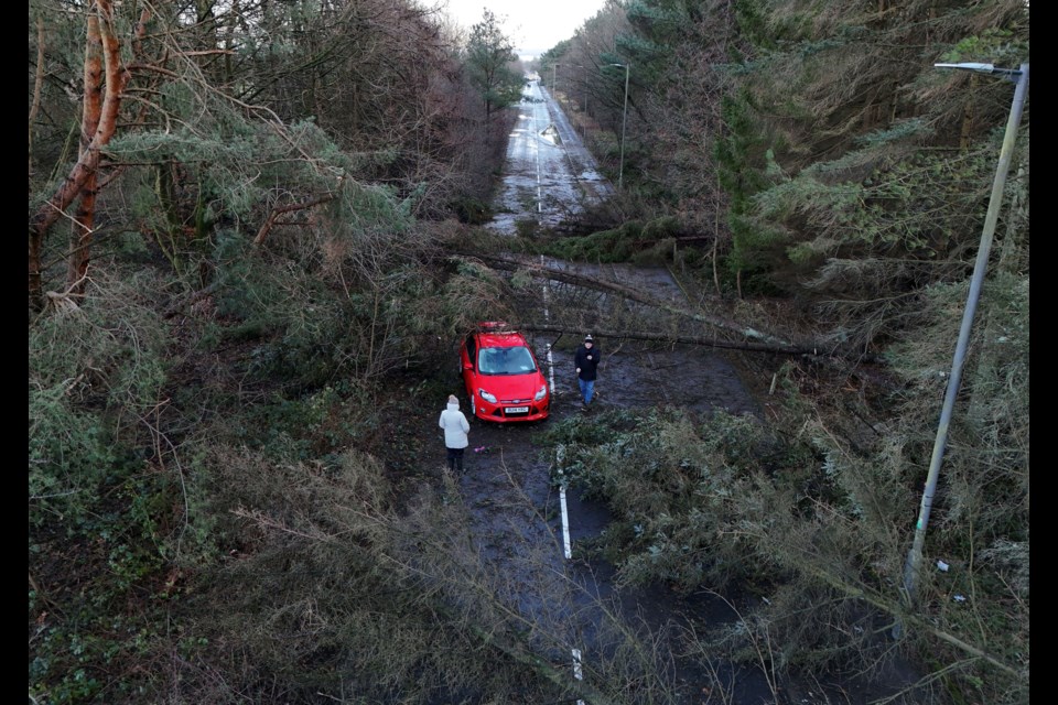 A car abandoned in Tryst Road in Larbert surrounded by fallen trees after Storm Eowyn, in Larbert, Scotland, Saturday, Jan. 25, 2025. (Andrew Milligan/PA via AP)