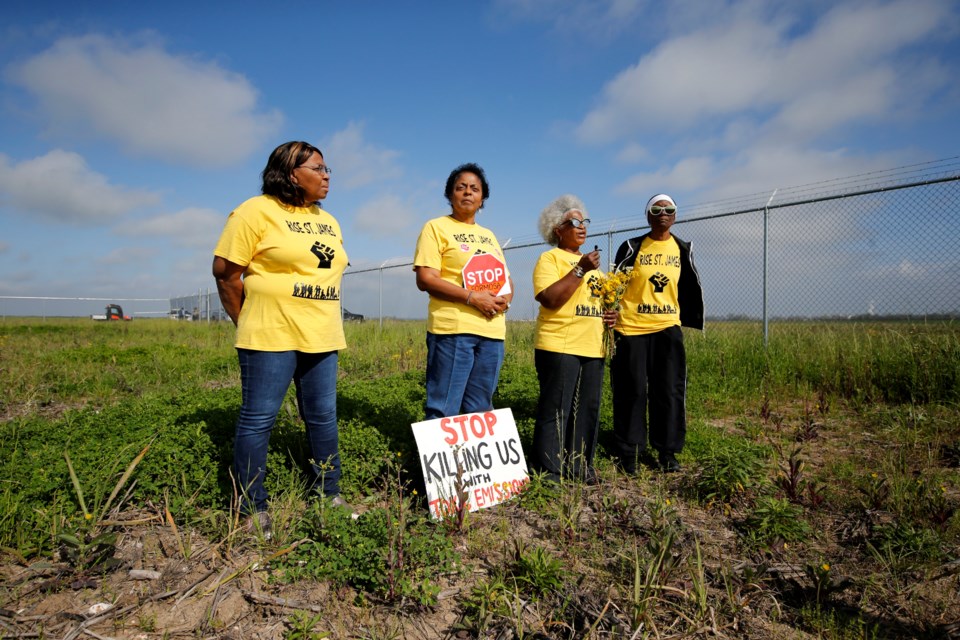 FILE - Myrtle Felton, from left, Sharon Lavigne, Gail LeBoeuf and Rita Cooper, members of RISE St. James, conduct a live stream video on property owned by Formosa on March 11, 2020, in St. James Parish, La. (AP Photo/Gerald Herbert, File)