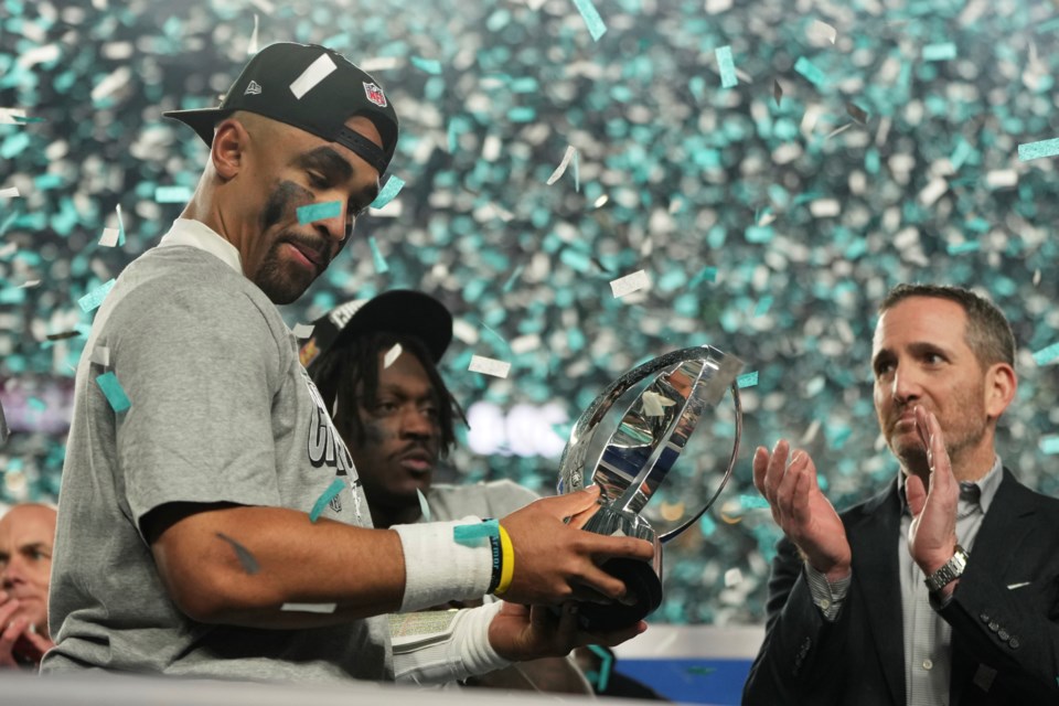 Philadelphia Eagles quarterback Jalen Hurts holds the championship trophy after the Eagles won the NFC Championship NFL football game against the Washington Commanders, Sunday, Jan. 26, 2025, in Philadelphia. (AP Photo/Matt Slocum)