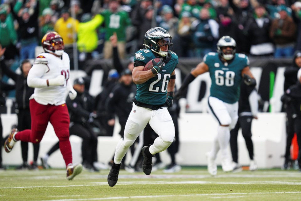 Philadelphia Eagles running back Saquon Barkley (26) runs for a touchdown against the Washington Commanders during the first half of the NFC Championship NFL football game, Sunday, Jan. 26, 2025, in Philadelphia. (AP Photo/Derik Hamilton)