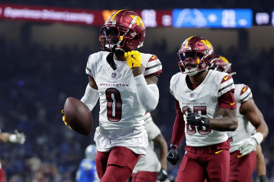 Washington Commanders cornerback Mike Sainristil (0) reacts to his interception against the Detroit Lions during the first half of an NFL football divisional playoff game, Saturday, Jan. 18, 2025, in Detroit. (AP Photo/Rey Del Rio)