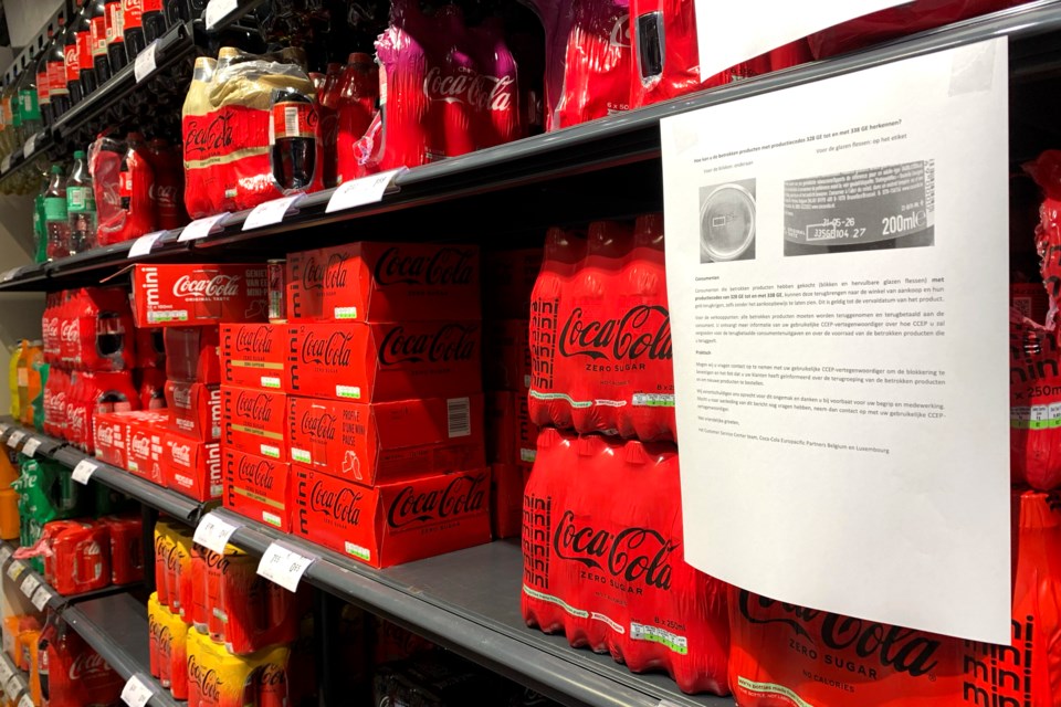 A note is posted next to cleared cases of soft drinks sitting on a shelf in a supermarket in Antwerp, Belgium, after Coca-Cola recalled some of its soft drinks in Europe, Tuesday, Jan. 28, 2025. (AP Photo/Virginia Mayo)