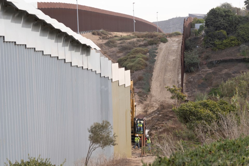 FILE - Construction crews replace sections of one of two border walls separating Mexico from the United States, Wednesday, Jan. 22, 2025, in Tijuana, Mexico. (AP Photo/Gregory Bull, File)