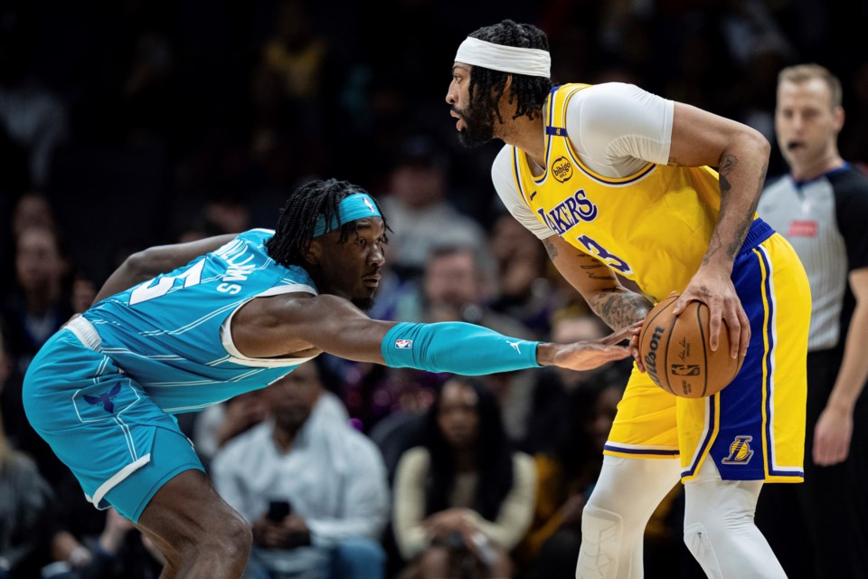 Charlotte Hornets center Mark Williams (5) guards against Los Angeles Lakers forward Anthony Davis (3) during the first half of an NBA basketball game Monday, Jan. 27, 2025, in Charlotte, N.C. (AP Photo/Jacob Kupferman)