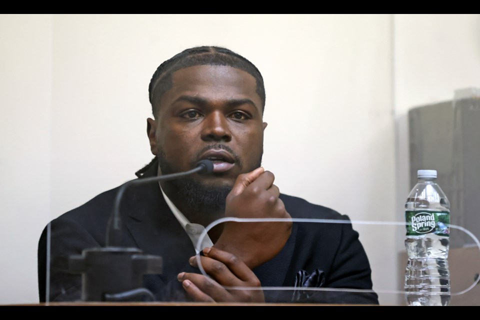 New England Patriots safety Jabrill Peppers shows hows his accuser grabbed his wrist as he testifies in his assault and battery trial, Friday, Jan. 24, 2025, in Quincy, Mass. (David L. Ryan/The Boston Globe via AP, Pool)