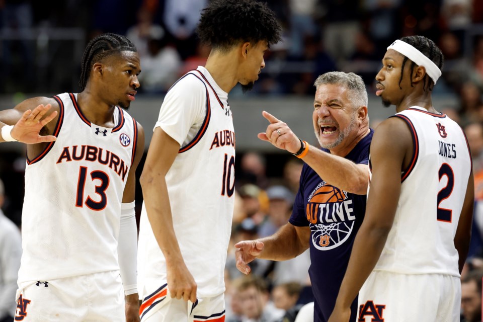 Auburn head coach Bruce Pearl, second from right, talks with players during a timeout in the second half of an NCAA college basketball game against Tennessee, Saturday, Jan. 25, 2025, in Auburn, Ala. (AP Photo/Butch Dill)