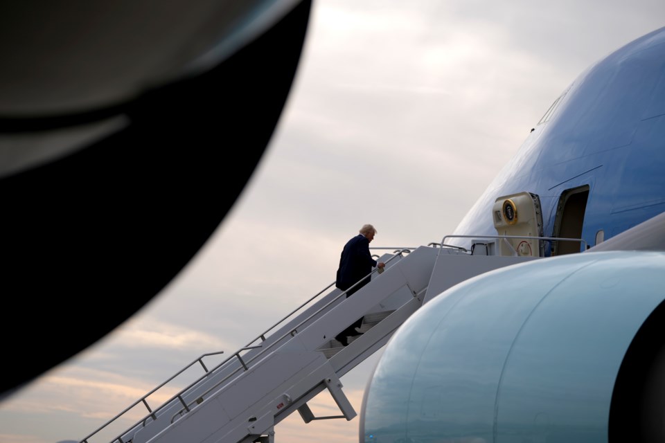 President Donald Trump boards Air Force One en route to Florida at Harry Reid International Airport in Las Vegas, Saturday, Jan. 25, 2025. (AP Photo/Mark Schiefelbein)