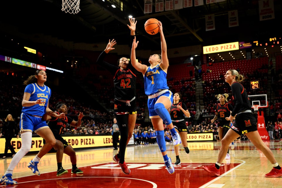 UCLA guard Kiki Rice (1) goes to the basket against Maryland forward Amari DeBerry (42) during the first half of an NCAA college basketball game, Sunday, Jan. 26, 2025, in College Park, Md. (AP Photo/Nick Wass)