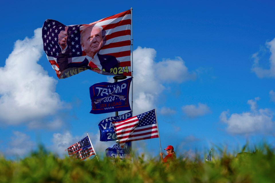 FILE - Supporters display MAGA flags near the Mar-a-Lago estate of President-elect Donald Trump, in Palm Beach, Fla., Nov. 12, 2024. (AP Photo/Julia Demaree Nikhinson, File)